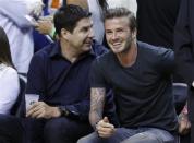 Soccer player David Beckham sits before Game 5 of the NBA Eastern Conference final basketball playoff between the Indiana Pacers and the Miami Heat in Miami, Florida May 30, 2013. REUTERS/Joe Skipper