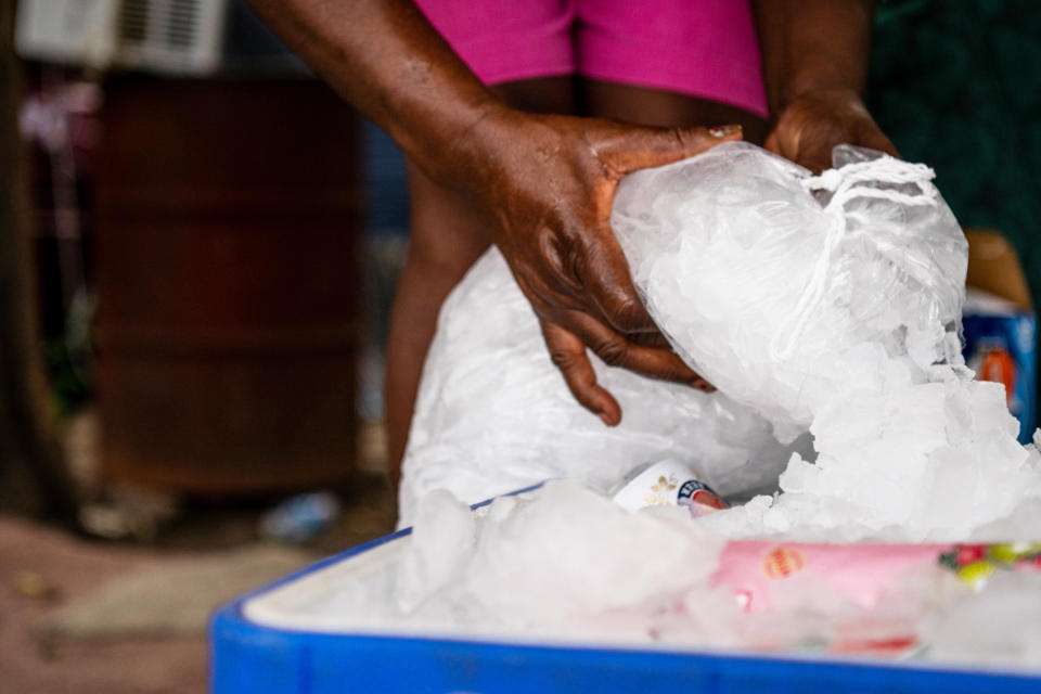 A woman fills an ice chest (Brandon Bell / Getty Images)