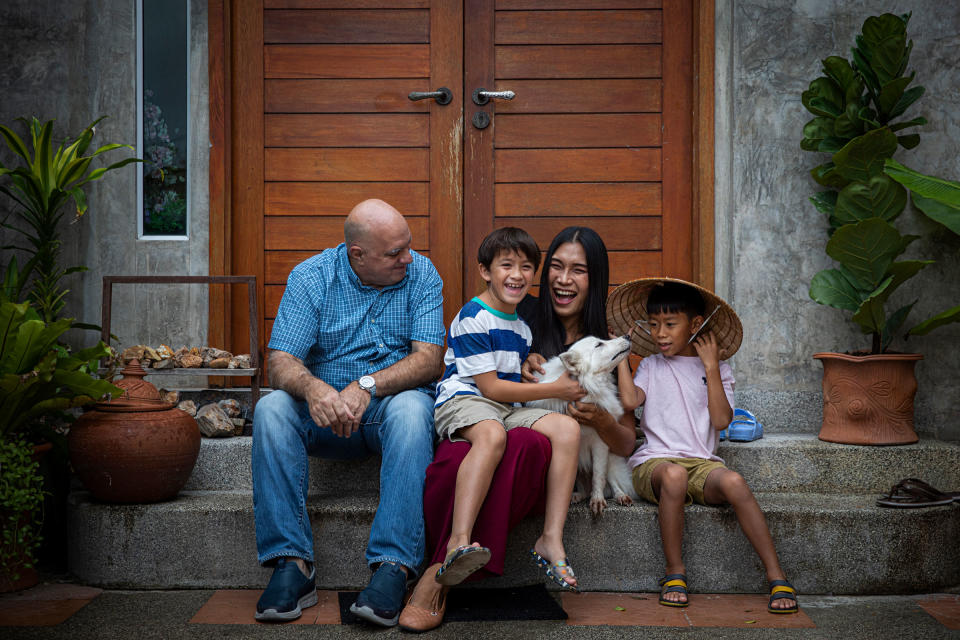 Lee, Gina, Chene and Charlie pose for a portrait with their dog Casper, in front of their home on July 12.<span class="copyright">Lauren DeCicca for TIME</span>