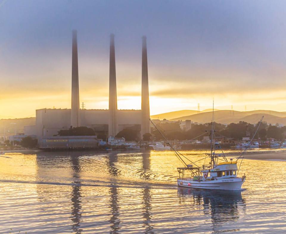 The Morro Bay-based Michael Too heads out to sea on a salmon-fishing trip as the sun rises behind the power plant. 