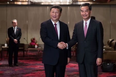 China's President Xi Jinping shakes hands with outgoing Hong Kong Chief Executive Leung Chun-ying during a meeting in a hotel in Hong Kong, China, June 29, 2017. REUTERS/Dale De La Rey/Pool