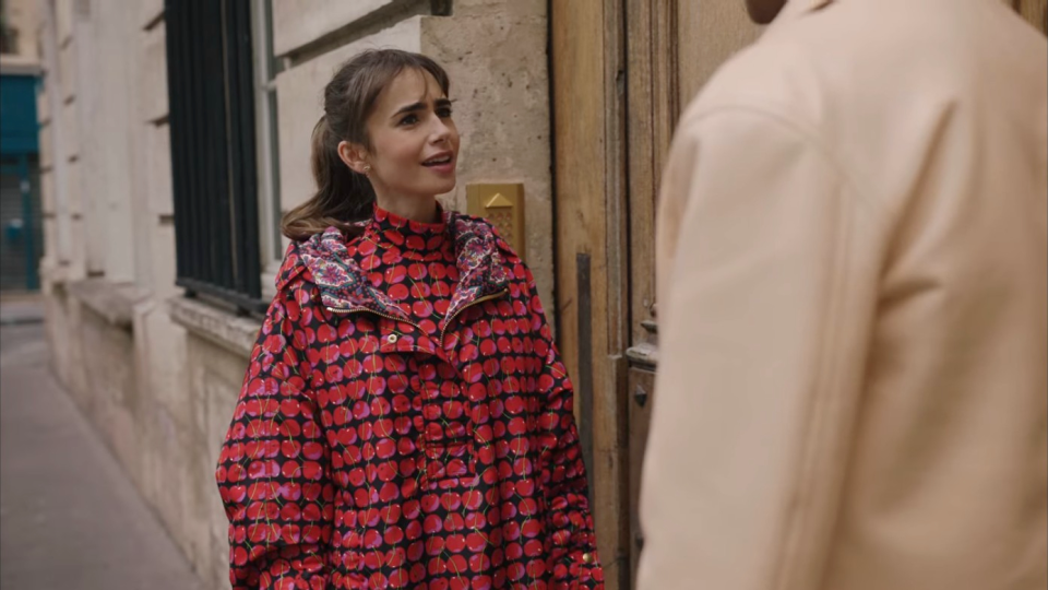 lily collins wearing a cherry patterned anorak in emily in paris season 3