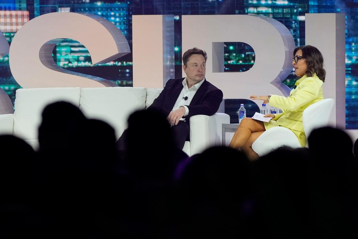 Twitter CEO Elon Musk, center, speaks with Linda Yaccarino, former chairman of global advertising and partnerships for NBC at the POSSIBLE marketing conference last month in Miami Beach.