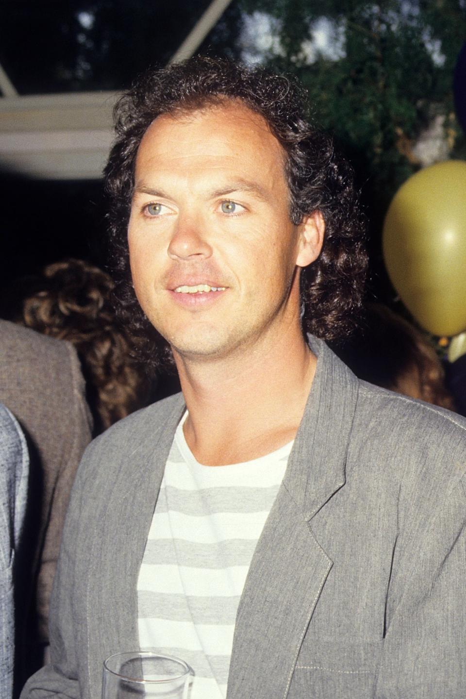 Michael Keaton in a casual striped shirt and jacket