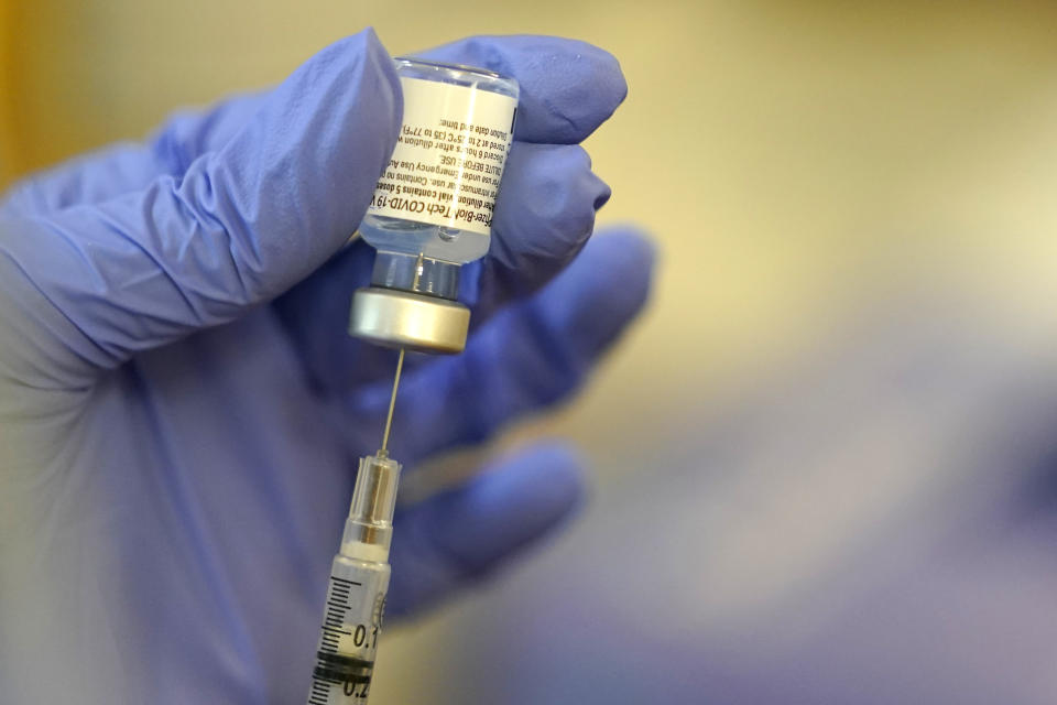 A pharmacist prepares a syringe of the Pfizer-BioNTech COVID-19 vaccine Friday, Jan. 8, 2021, at Queen Anne Healthcare, a skilled nursing and rehabilitation facility in Seattle. Pfizer has committed to supply up to 40 million doses of its COVID-19 vaccine this year to a World Health Organization-backed effort to get affordable vaccines to 92 poor and middle-income countries. The deal announced Friday, Jan. 22 will supply the shots to the program known as COVAX. (AP Photo/Ted S. Warren)