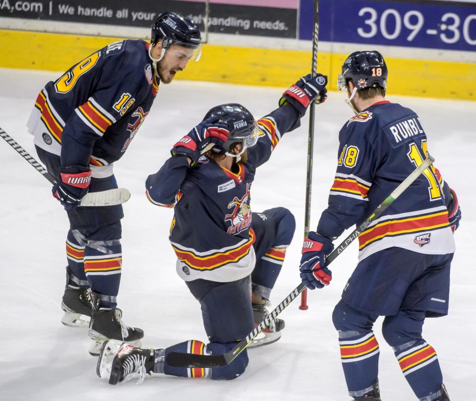 Peoria's Zach Wilkie, left, Jordan Ernst, middle, and Brandon Rumble celebrate Ernst's game-winning goal against Quad City in the third period of their SPHL semifinal Saturday, April 23, 2022 at Carver Arena in Peoria.