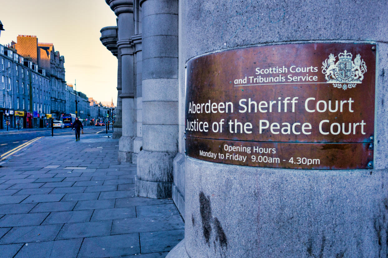 Aberdeen, Scotland, UK - February 10 2019:  Both Aberdeen Sheriff Court and Justice of the Peace Court are governed by the Scottish Courts and Tribunals Service and deal with summary and solemn crime and criminal business.  This is the entrance to this large granite ’grade A’ listed building built in the 19th century located on Castle Street, Aberdeen.  It also houses Sheriffs, Sheriff Clerk, the court Social Work Department, Witness Services and the Police cells.