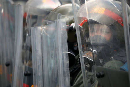 Riot police officers clash with opposition supporters during a rally against Venezuela's President Nicolas Maduro in Caracas, Venezuela April 26, 2017. REUTERS/Carlos Garcia Rawlins