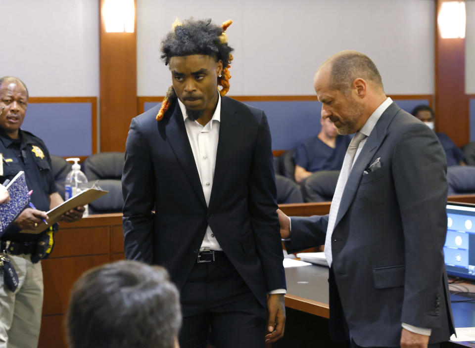 Former NFL cornerback Damon Arnette, left, leaves the courtroom with his attorney Ross Goodman following his arraignment at the Regional Justice Center, Wednesday, May 24, 2023, in Las Vegas. Arnette pleaded not guilty to felony charges alleging that he brandished a handgun during an argument with Las Vegas Strip casino valets in January 2022, and his lawyer is challenging his indictment. (Bizuayehu Tesfaye/Las Vegas Review-Journal via AP)