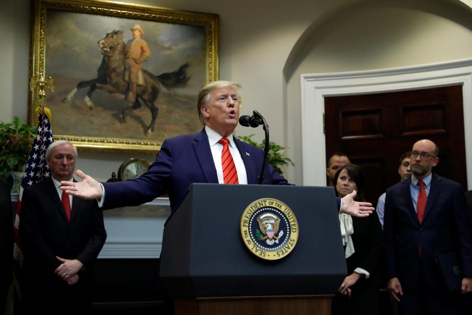 President Donald Trump answers questions from reporters during an event on 