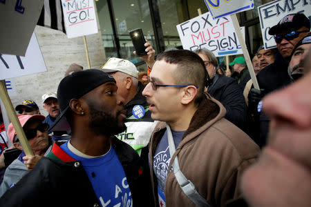 Jedidiah Brown (L) faces off with a Fraternal Order of Police supporter protesting the handling of the Jussie Smollett case by the State's Attorney Kim Foxx in Chicago, Illinois, U.S., April 1, 2019. REUTERS/Joshua Lott