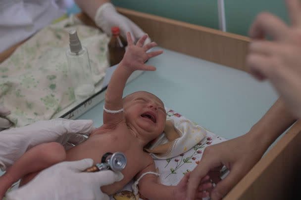 PHOTO: Marina Tupata, 26, watches as her six-day-old baby Sofia is examined inside Pokrovsk maternity hospital, Donetsk region, eastern Ukraine, June 29, 2022. (Marko Djurica/Reuters)