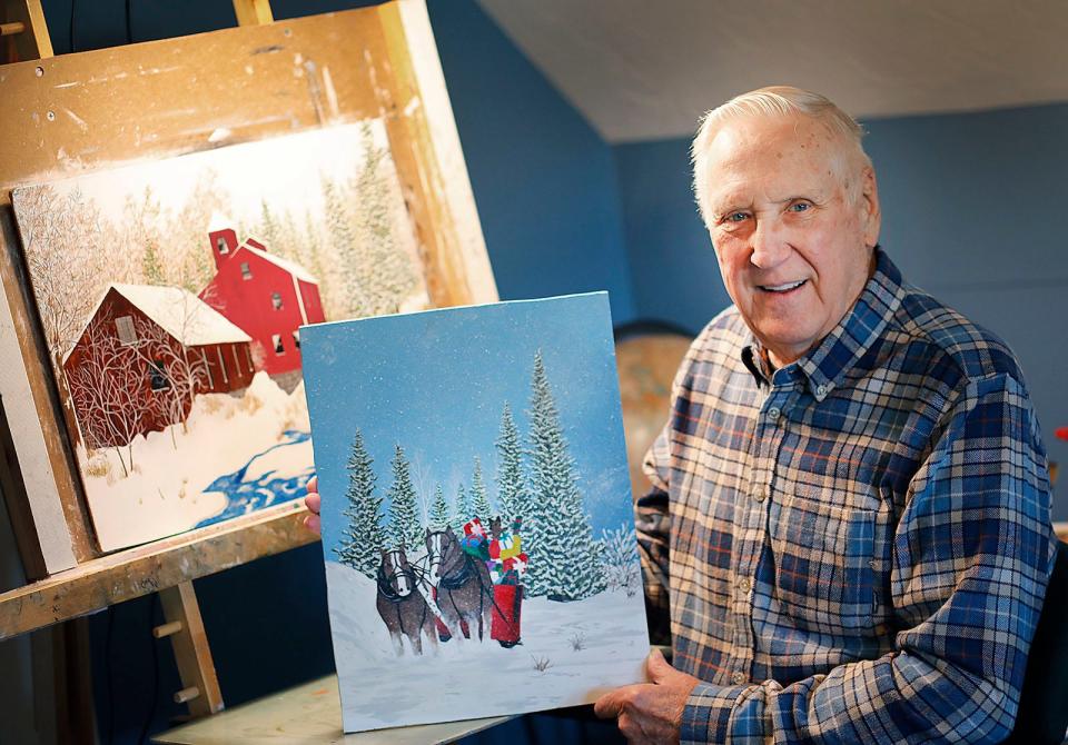 Brad Nelson, 83, of Quincy, with his winning holiday painting on Thursday Dec. 21, 2023