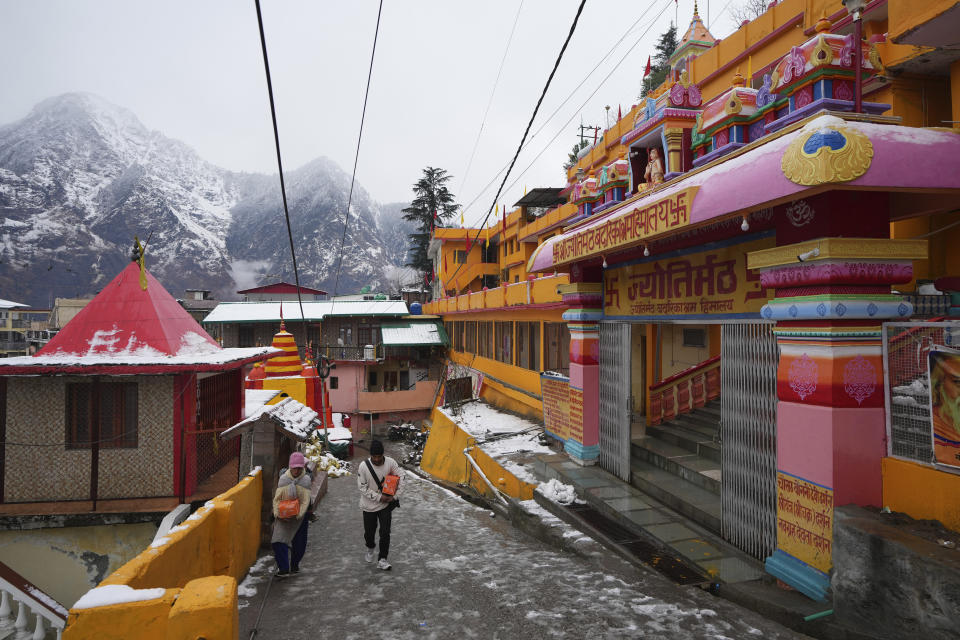 Hindu pilgrims visit famed Adi Shankaracharya monastery, in Joshimath, in India's Himalayan mountain state of Uttarakhand, Jan.20, 2023. For decades, scientists have warned that the holy town, built on piles of debris left behind from years of landslides and earthquakes, could not withstand heavy construction. A report from 1976 said that Joshimath's location along a slope and over a geological fault line made it inherently unstable. Its foundation of loose top soil and soft rocks had a carrying limit. (AP Photo/Rajesh Kumar Singh)