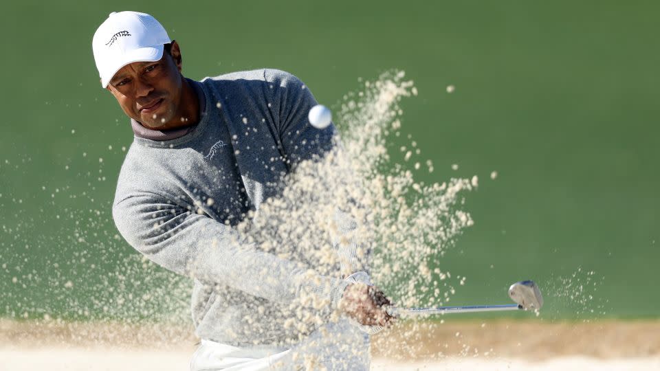 Woods escapes a bunker during the first round. - Warren Little/Getty Images