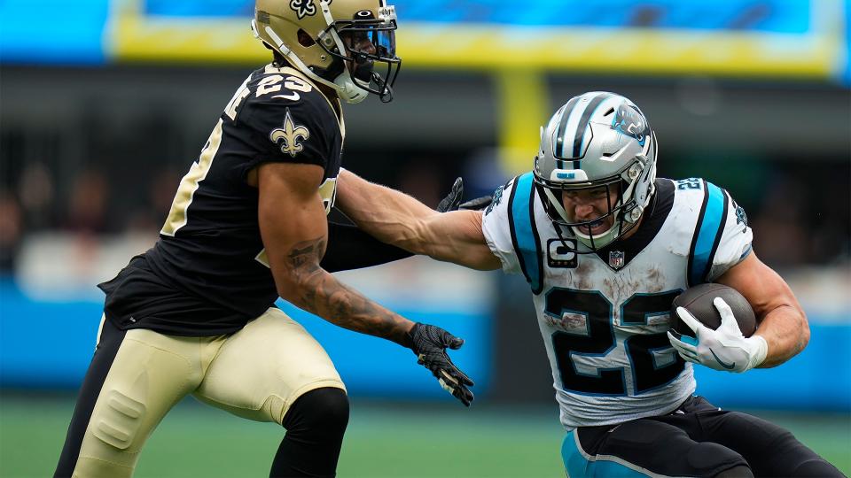 Carolina Panthers running back Christian McCaffrey (22) runs the ball against New Orleans Saints cornerback Marshon Lattimore (23) during the second half of an NFL football game, Sunday, Sept. 25, 2022, in Charlotte, N.C.