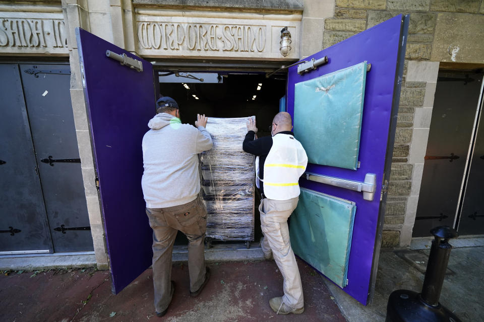 Chester County, Pa., workers transport mail-in and absentee ballots to be processed at West Chester University, Wednesday, Nov. 4, 2020, in West Chester. (AP Photo/Matt Slocum)