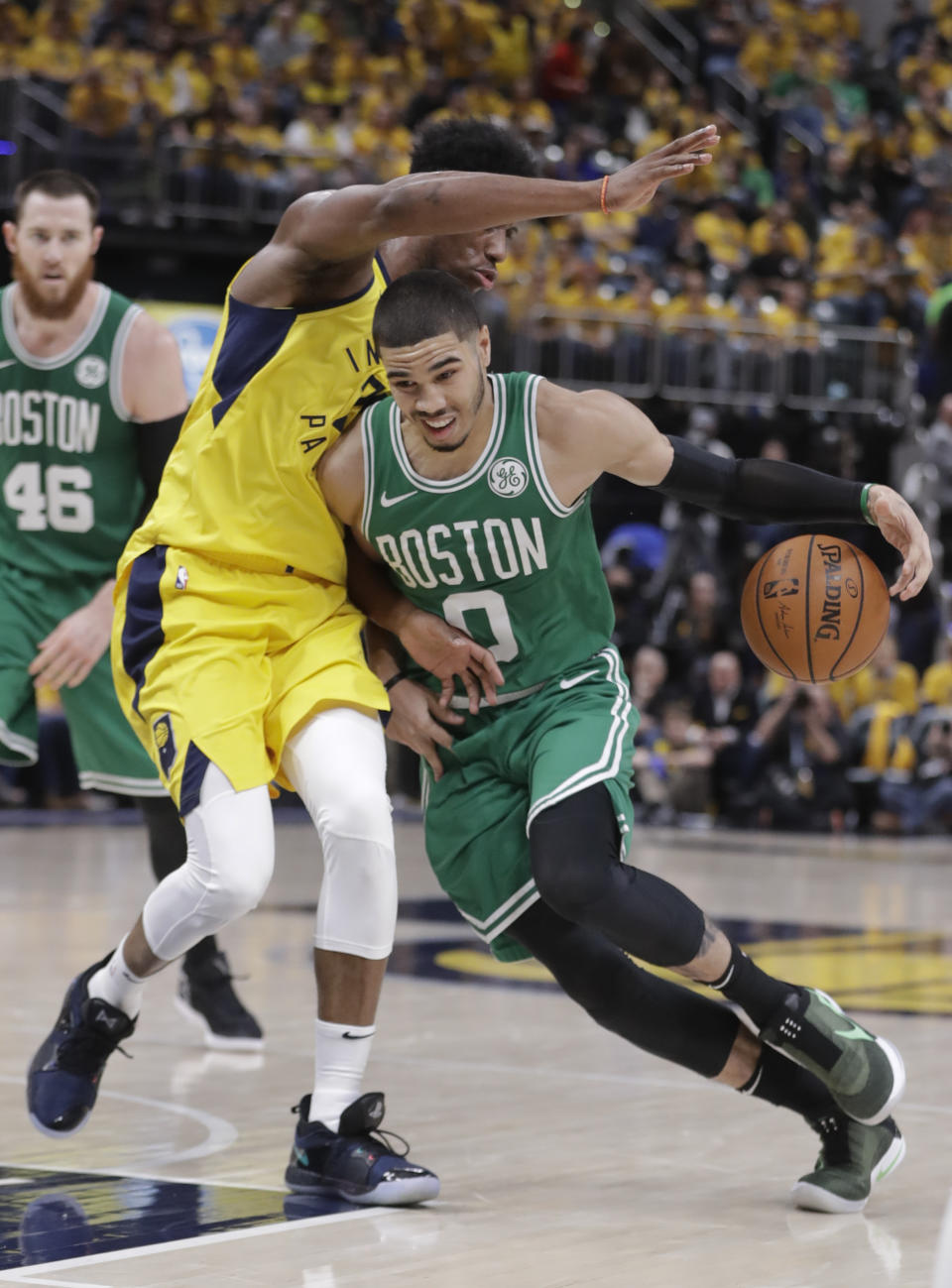 Boston Celtics forward Jayson Tatum (0) drives on Indiana Pacers forward Thaddeus Young (21) during the second half of Game 3 of an NBA basketball first-round playoff series Friday, April 19, 2019, in Indianapolis. (AP Photo/Darron Cummings)