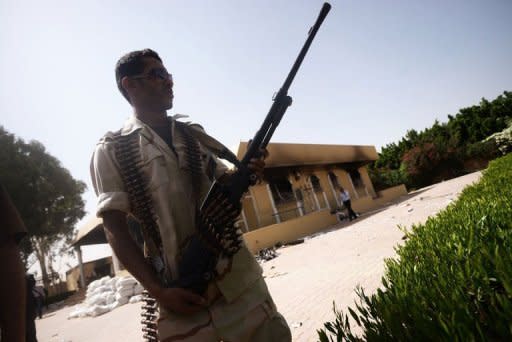 A member of the Libyan security forces secures the area during a visit by the head of Libya's national assembly, Mohammed al-Megaryef, to the US consulate compound in Benghazi. US military and intelligence agencies have launched an elaborate manhunt in Libya against the militants suspected of staging the most serious assault on an American diplomatic mission in decades, officials and experts said