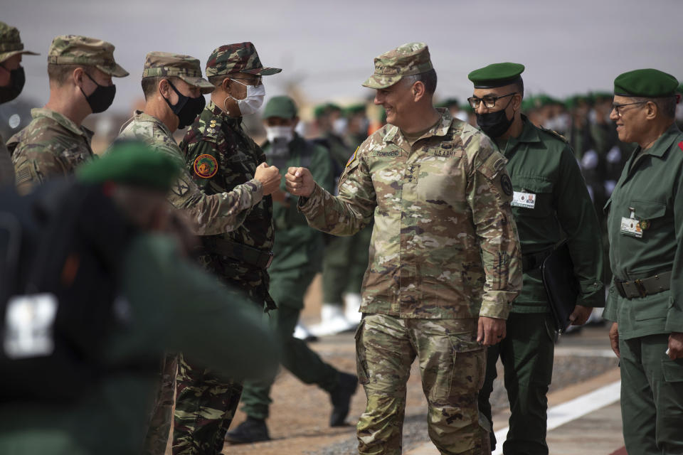 Gen. Stephen J. Townsend, head of the United States Africa Command, center, arrives alongside General Belkhir el-Farouk, Right, Moroccan Southern Zone Commander, to his right, to watch a large scale drill as part of the African Lion military exercise, in Tantan, south of Agadir, Morocco, Friday, June 18, 2021. The U.S.-led African Lion war games, which lasted nearly two weeks, stretched across Morocco, a key U.S, ally, with smaller exercises held in Tunisia and in Senegal, whose troops ultimately moved to Morocco. (AP Photo/Mosa'ab Elshamy)