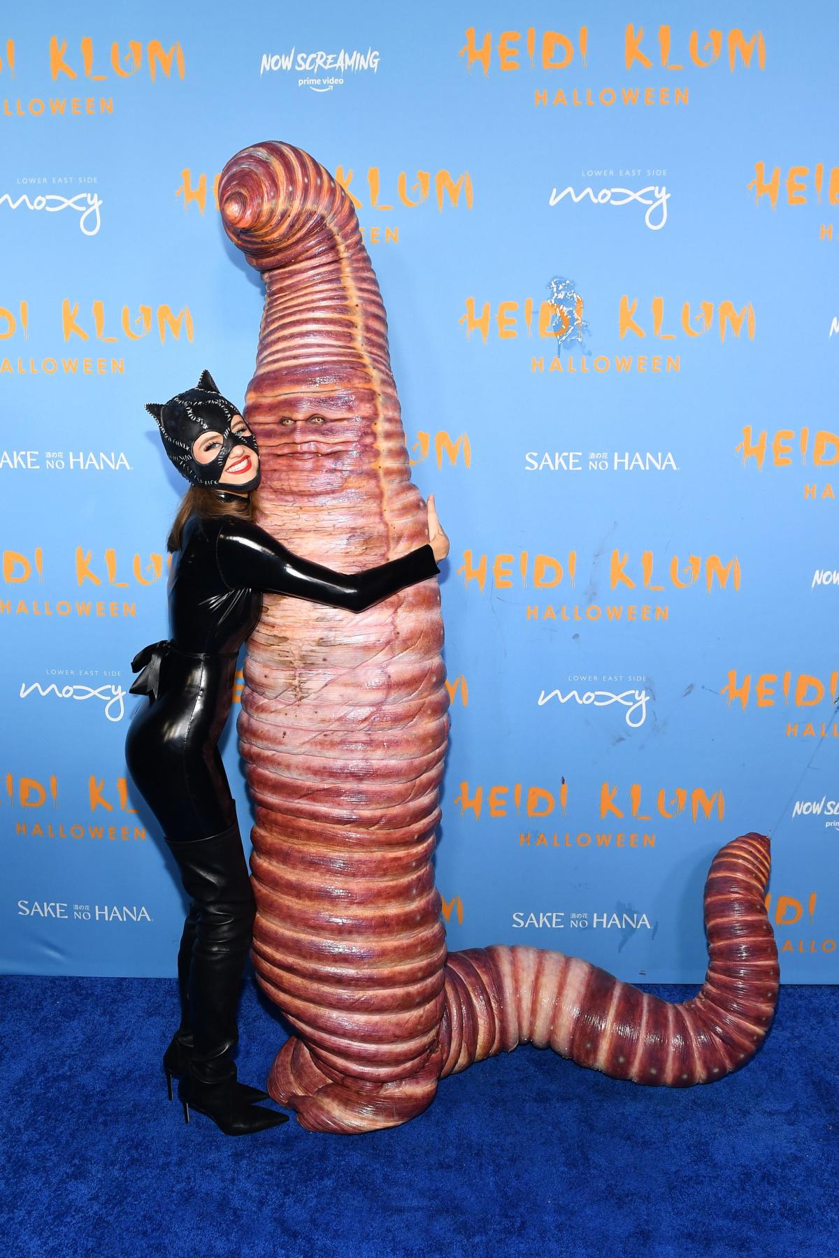 Heidi Klum crawls into her Halloween party as a fishing worm, gets hugs