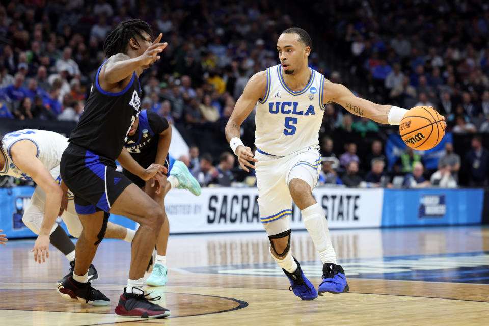 UCLA guard Amari Bailey controls the ball against UNC Asheville guard Caleb Burgess during a game last month. (Kelley L Cox/USA TODAY Sports)