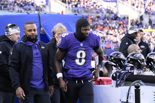 Baltimore Ravens quarterback Lamar Jackson (8) takes to the field with a  member of the military as part of Salute to Service before an NFL football  game against the Carolina Panthers, Sunday