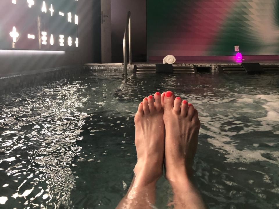 simone's feet sticking out of a hot tub in a spa at a temptation resort