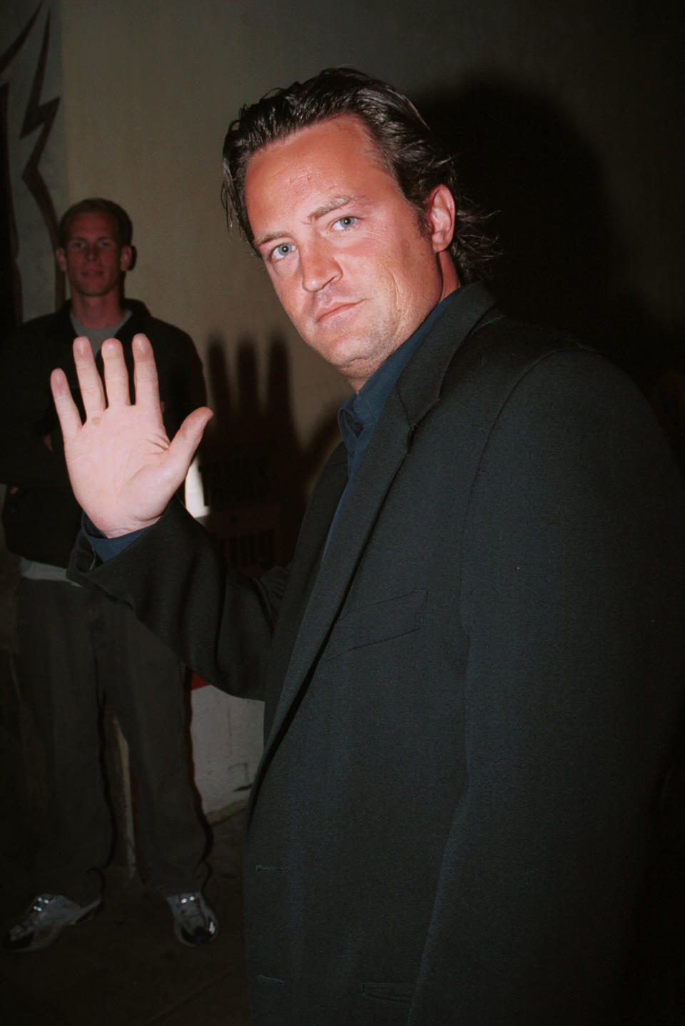 Matthew Perry showing off his short middle finger