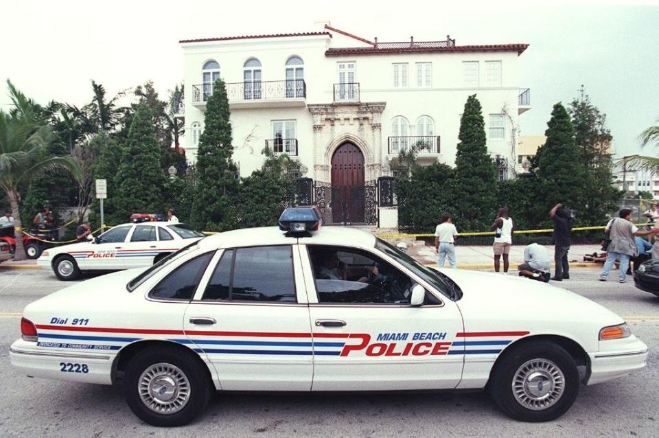 police and reporters outside the Versace house