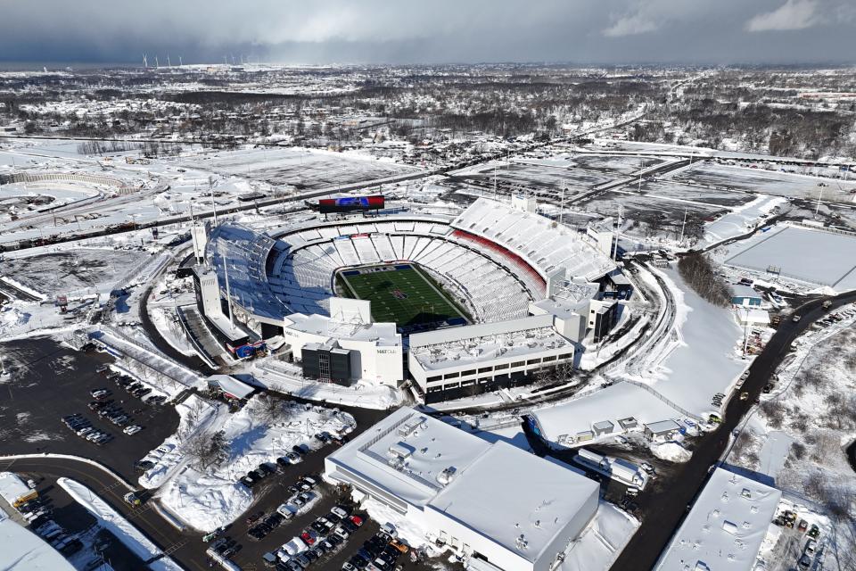 An aerial view Monday afternoon of a snow-covered Highmark Stadium and surrounding Orchard Park, New York before the AFC wild-card game between the Buffalo Bills and Pittsburgh Steelers.