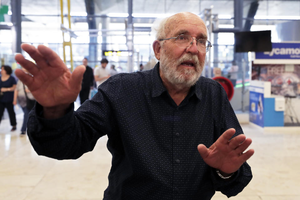 Swiss scientist Michel Mayor gestures after landing at the Barajas airport in Madrid, Tuesday, Oct. 8, 2019. Mayor has been jointly awarded the 2019 Nobel Prize in Physics along with Professor Didier Queloz and Professor James Peebles for their pioneering advances in physical cosmology, and the discovery of an exoplanet orbiting a solar-type star. (AP Photo/Manu Fernandez)