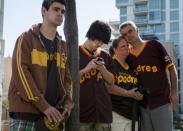 Alex Mcbrayer, 16, Trevor Herman, 17, Rebecca Herman, 54 and her friend Wayne Mcbrayer, 48, mourn at a makeshift memorial to former San Diego Padres outfielder Tony Gwynn at Petco Park in San Diego, California June 16, 2014. Gwynn, one of the greatest hitters of his generation, died on Monday at age 54 after a battle with cancer, the National Baseball Hall of Fame and Museum said. REUTERS/Sam Hodgson (UNITED STATES - Tags: SPORT BASEBALL OBITUARY)