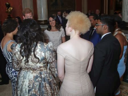 Britain's Prince Harry and Meghan, the Duchess of Sussex meet group of Queen's Young Leaders at a Buckingham Palace reception following the final Queen's Young Leaders Awards Ceremony, in London, June 26, 2018. Yui Mok/Pool via Reuters