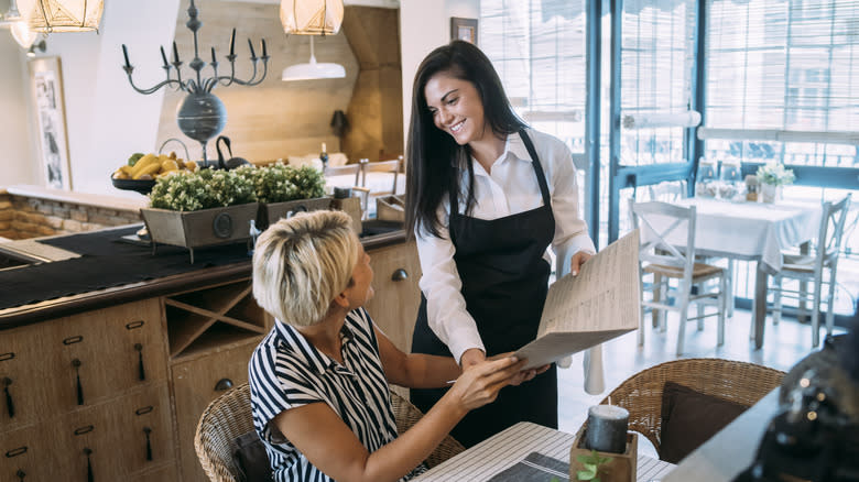 Waiter taking a customer's order