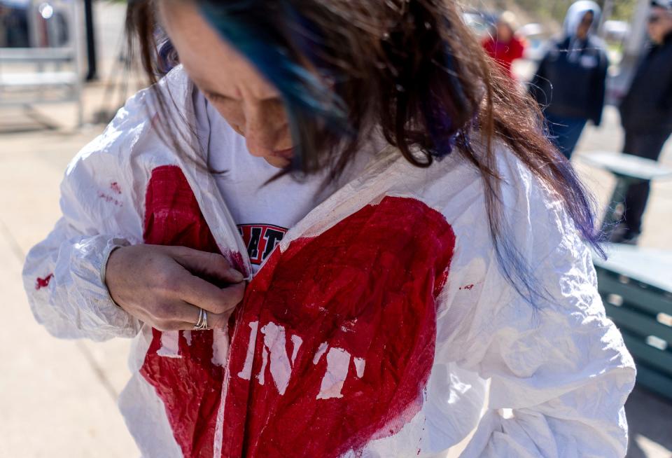 Christina Sayyae, of Flint, puts on an outfit in memory of the miscarriages that occurred during the Flint water crisis as people get ready to march to Flint City Hall during the 10th anniversary commemoration of the start of the Flint water crisis on Thursday, April 25, 2024.