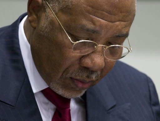 Former Liberian President Charles Taylor takes notes at the start of the judgement hearing of his trial. Taylor has been convicted of arming rebels during Sierra Leone's civil war in return for blood diamonds, in an historic verdict for international justice