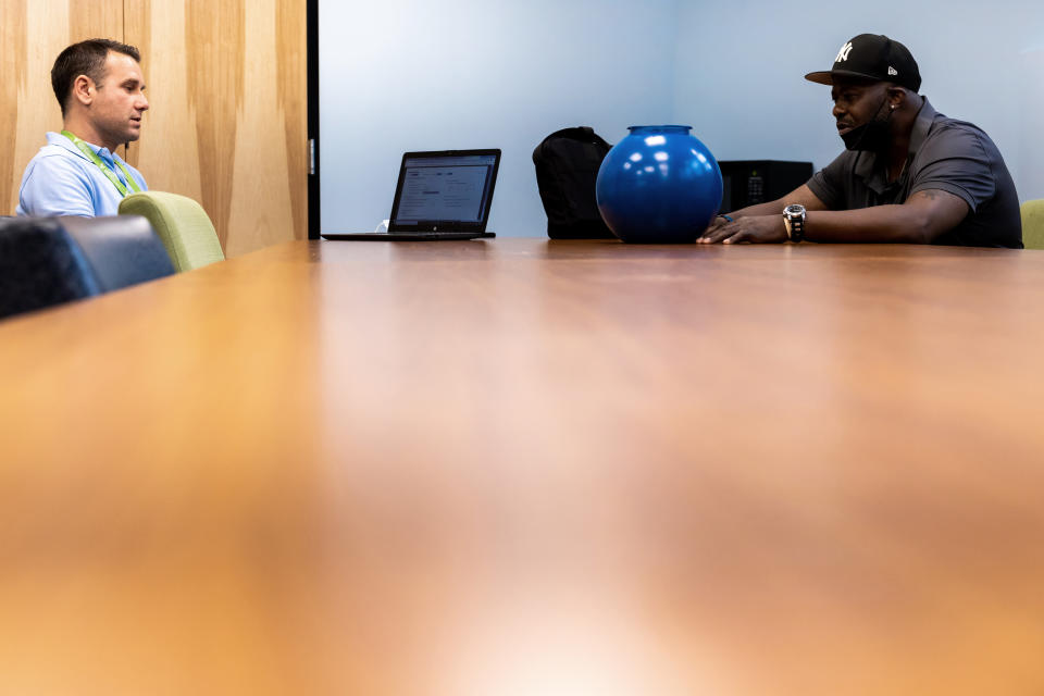 Clinical supervisor Bobby Boback talks to client Harold Lewis, Monday, July 18, 2022 at Liberation Programs in Bridgeport, Conn. The behavioral health organization specializes in treatment for substance use disorders. (AP Photo/Julia Nikhinson)