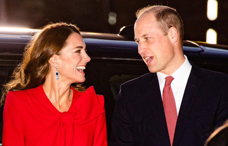 Kate Middleton and Prince William looking at each other outside Christmas carol concert