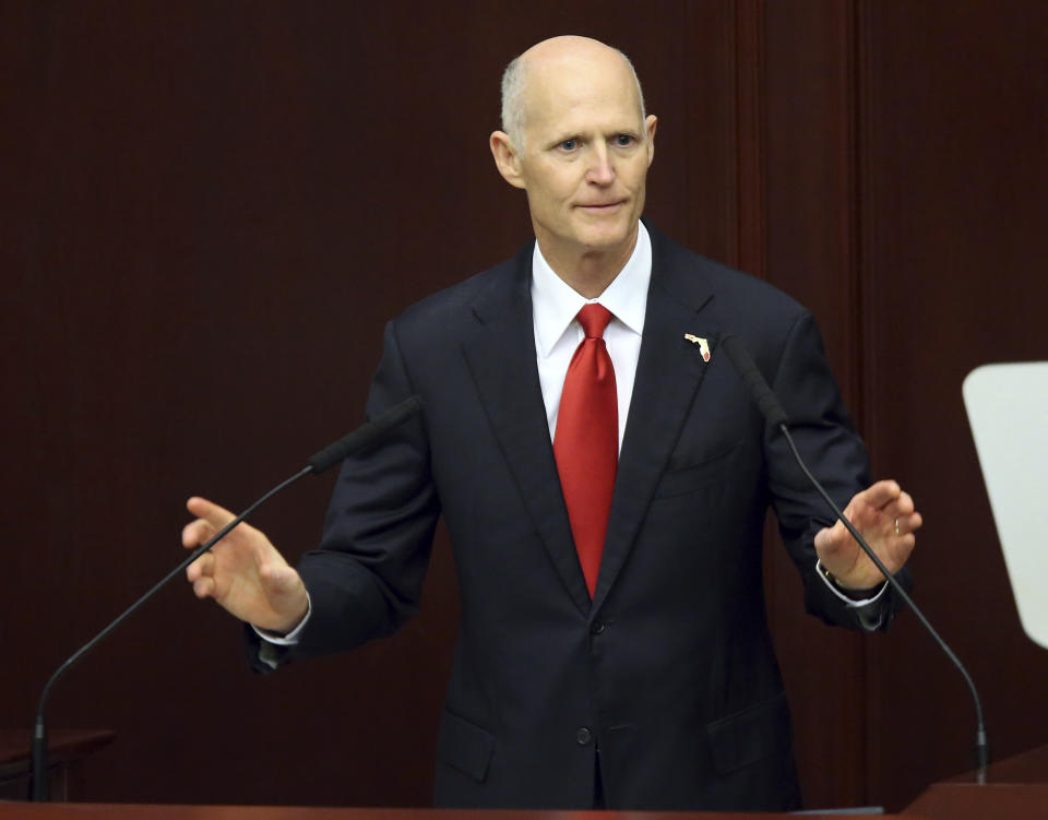 FILE - In this Tuesday, March 7, 2017, file photo, Gov. Rick Scott makes the state of the state address to the joint session of the legislature in Tallahassee, Fla. State Attorney Aramis Ayala has fired a double-barreled response to Scott’s efforts to take away almost two-dozen cases after she said her office would no longer seek the death penalty. Ayala on Tuesday, April 11, 2017, filed lawsuits in state and federal courts, challenging Scott’s ability to remove her from death-penalty cases. (AP Photo/Steve Cannon, File)