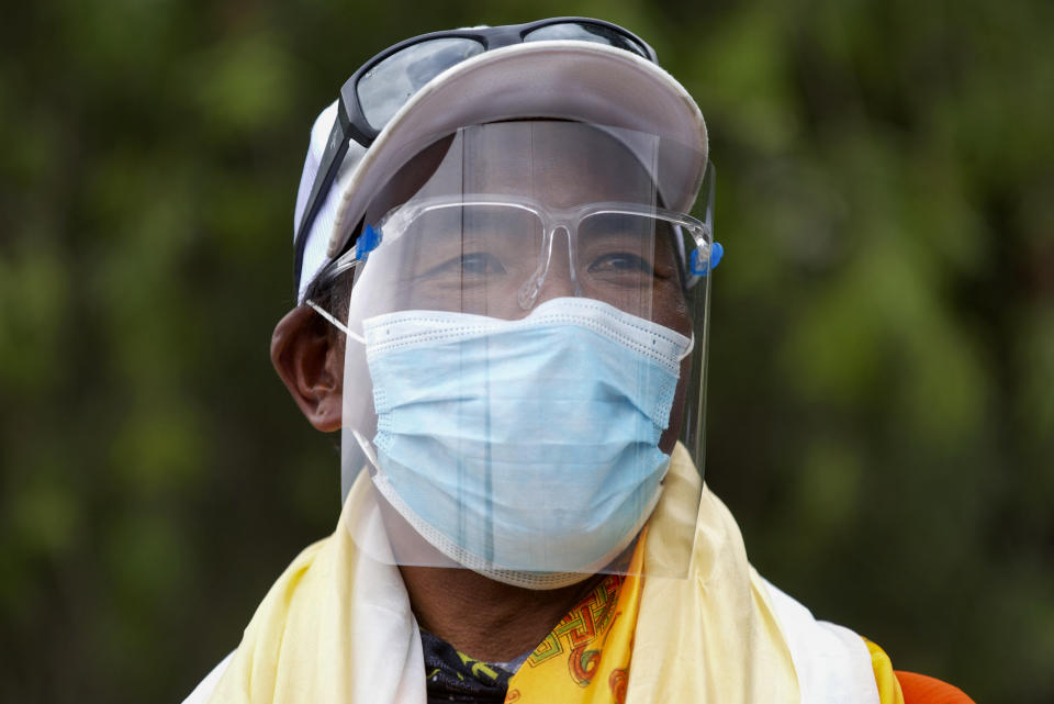 Veteran Sherpa guide Kami Rita who returned from the mountains on a helicopter arrives at the airport in Kathmandu, Nepal, Tuesday, May 25, 2021. The record-holding Sherpa climber halted his attempt to scale Mount Everest for a 26th time because of a bad dream but plans to try again next year. (AP Photos/Bikram Rai)