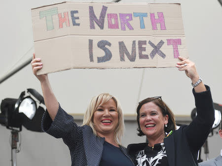 Sinn Fein leader Mary Lou McDonald and Michelle O'Neill leader of Sinn Fein in Northern Ireland hold up a placard as they celebrate the result of yesterday's referendum on liberalizing abortion law, in Dublin, Ireland, May 26, 2018. REUTERS/Clodagh Kilcoyne