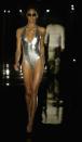 <p>Metallic lamé one-pieces and bikinis were huge in 2003, as this runway model proves.</p>