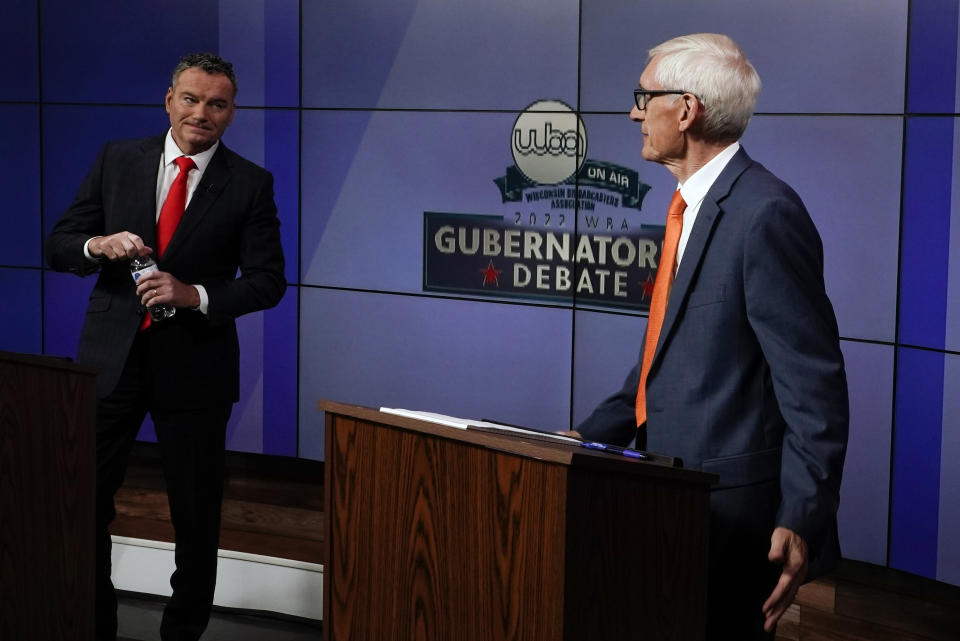 Wisconsin Republican gubernatorial candidate Tim Michels, left, and Democratic gubernatorial candidate Tony Evers talk before a televised debate Friday, Oct. 14, 2022, in Madison, Wis. (AP Photo/Morry Gash)