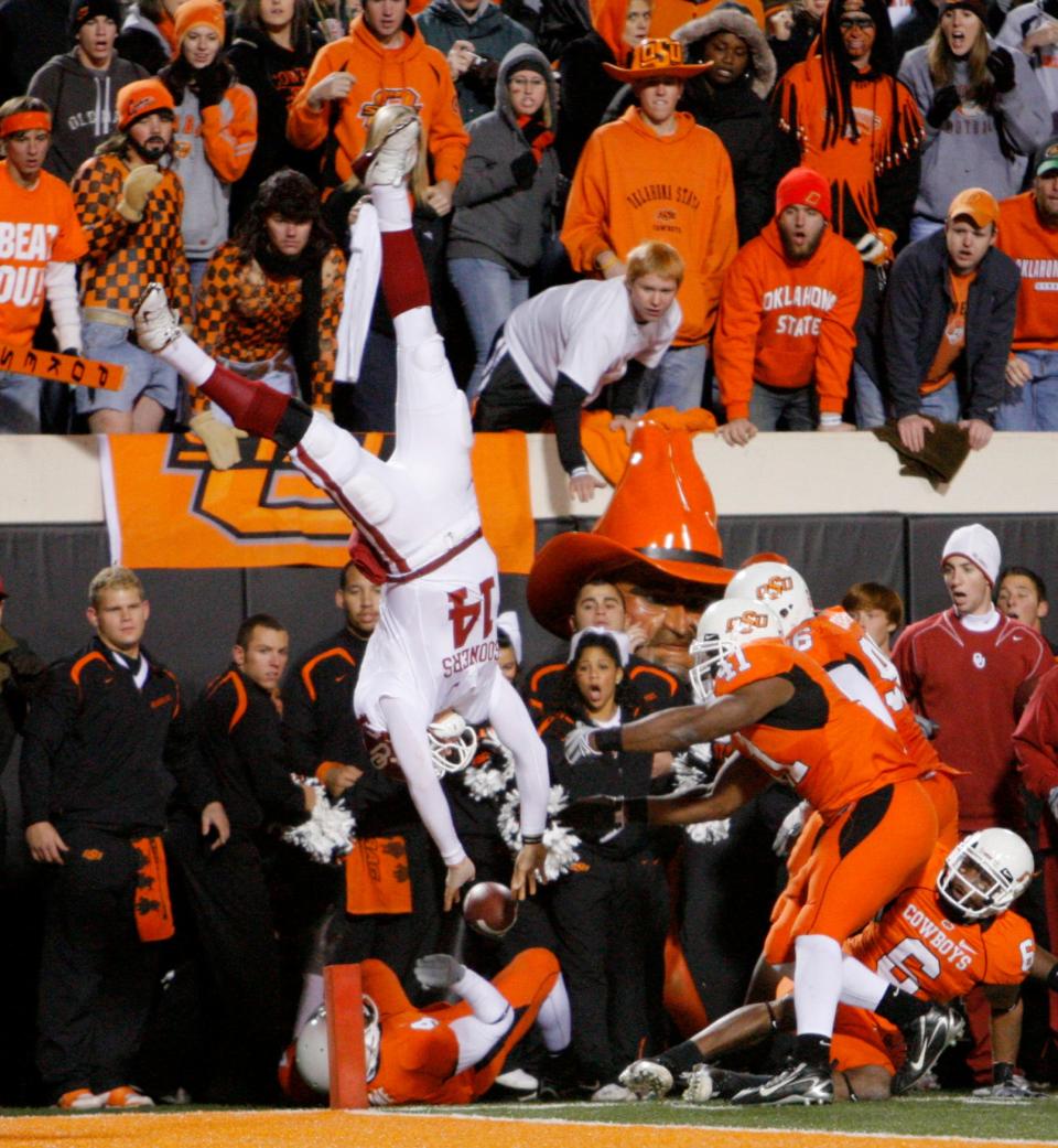 OU's Sam Bradford is flipped out of bounds by OSU's Orie Lemon on Saturday, Nov. 29, 2008, during the second half of the college football game between the University of Oklahoma Sooners (OU) and Oklahoma State University Cowboys (OSU) at Boone Pickens Stadium in Stillwater.
