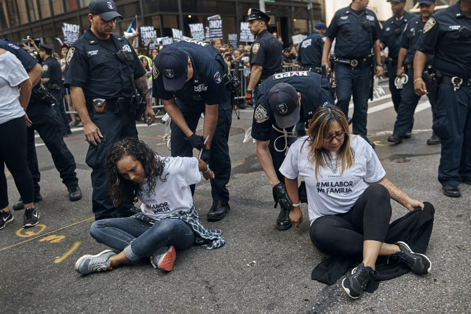 Police arrest activists as they block Fifth Avenue during a protest against President Donald Trump’s immigration policies in New York, Tuesday, Sept. 5, 2017. Police have handcuffed and removed over a dozen immigration activists who briefly blocked Fifth Avenue in Manhattan in front of Trump Tower. The protest Tuesday began with a march down the avenue and grew to about 400 people. The Trump administration has announced that it will wind down a program protecting young immigrants from deportation. (AP Photo/Andres Kudacki)