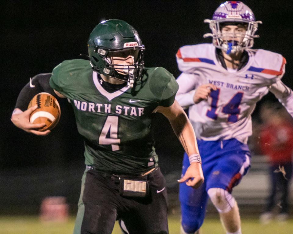 North Star's Ethan Eller runs down the sidelines ahead of West Branch defender Conner Danko during an Inter-County Conference matchup, Oct. 27, in Boswell.