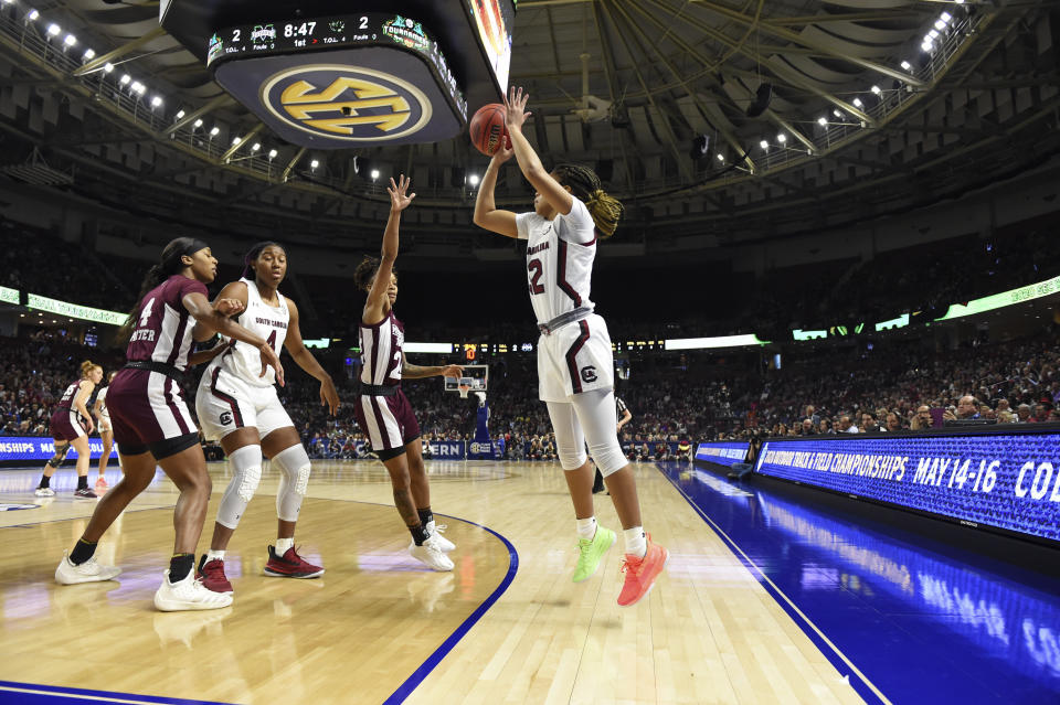 South Carolina's Tyasha Harris, right, shoots a three-point basketwhile defended by Mississippi State's Jordan Danberry, center right, during a championship match at the Southeastern Conference women's NCAA college basketball tournament in Greenville, S.C., Sunday, March 8, 2020. (AP Photo/Richard Shiro)