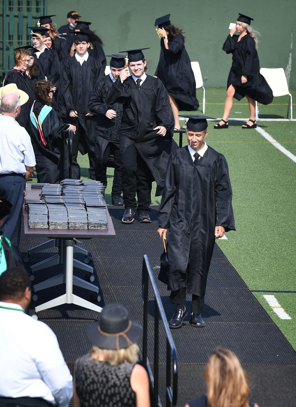 Rider High School students receive their diplomas during their graduation ceremony at Memorial Stadium as shown by this June 4, 2020, file photo.