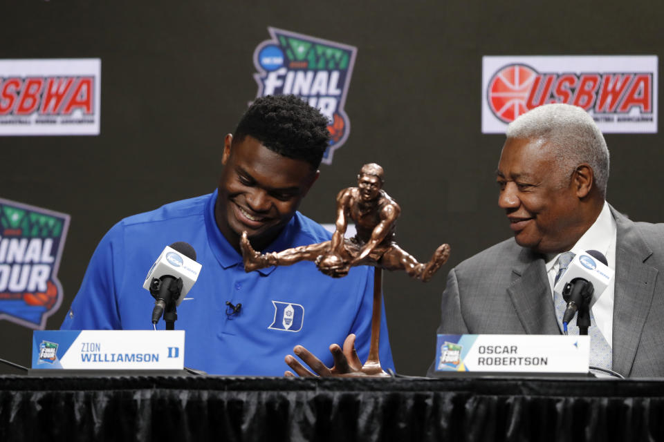 Duke freshman Zion Williamson sits behind the Oscar Robertson Trophy with National Collegiate Basketball Hall of Fame member Oscar Robertson at a news conference where Williamson was awarded the U.S. Basketball Writers Association College Player of the Year award at the Final Four NCAA college basketball tournament, Friday, April 5, 2019, in Minneapolis. (AP Photo/Charlie Neibergall)